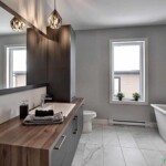 Salle de bain moderne avec baignoire et lavabo.